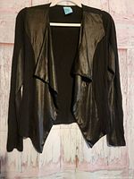 Front view of black H.I.P. open cardigan on hanger showing faux leather panels