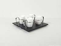 Full view of four cups arranged on black tray