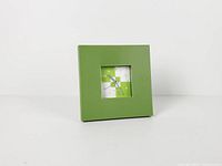 Front angled view showing green plastic frame and depth