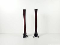 Full view of both matching tall amethyst glass vases standing upright