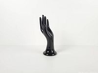 Front view of black glossy ceramic hand mannequin