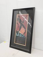 Full view of framed print upright on table, showing frame and artwork