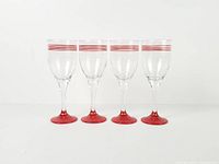 Four stemmed wine glasses aligned