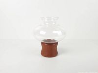 assembled candle holder showing teak base and glass chimney