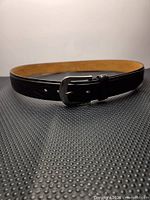Belt coiled to show exterior and buckle