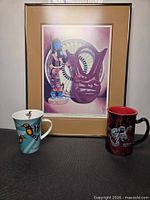 Overall view of framed print and two mugs