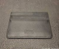 Front of black Kickers leather card holder showing logo and two card slots