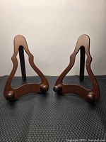 Pair of wooden plate easels standing upright showing front view and ball feet