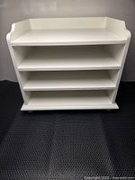 Front view of white three-shelf desktop organizer