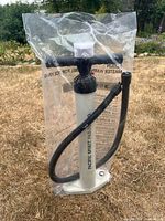 Front view of sealed Pacific Spirit Paddle Co. double-action pump with hose
