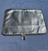 Front view of black leather laptop sleeve