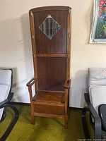 Full view of oak hall tree bench showing mirror, hooks, armrests and storage seat