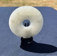 Front view of translucent stone bi disc on stand