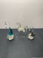 Front view of all three glass figurines