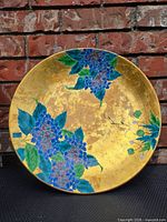 Front view of porcelain charger showing gold ground and hydrangea decoration
