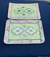 Both jade tile placemats front view showing mosaic pattern and brocade trim