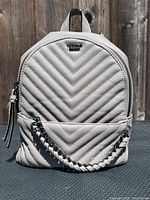 Front view of light gray Victoria's Secret chevron-quilted mini backpack showing overall design and condition