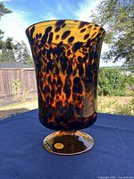 Full view of vase showing tortoiseshell pattern and flared rim