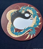 front view of round mirror showing dragon and yin-yang design
