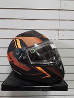 Left side view of CKX Tranz helmet showing graphics and visor