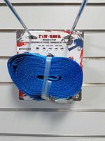 Front of packaged Erickson blue winch strap showing dimensions and capacity