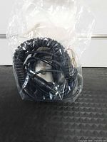 Coiled cord sealed in clear plastic bag