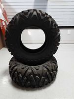 Two Kimpex Trail Trooper ATV tires stacked showing tread pattern
