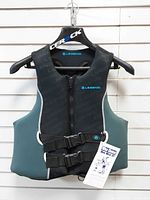 Front view of Legend neoprene life jacket showing zipper, buckle straps and hang tag