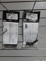 Two sealed Polaris handlebar hook kits hanging on display