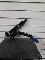 Full side profile of latch lever showing mounting end and blue handle