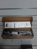 Open box showing bubble-wrapped handguard light module, wiring, instructions