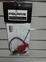 Front view of packaged Polaris tether/kill switch kit showing brand card and contents