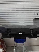Closed cargo box on display, showing exterior and latches