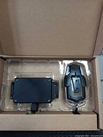 Receiver module and wireless remote with holder in factory plastic tray