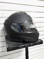 Left side profile showing matte black shell, clear visor, modular hinge