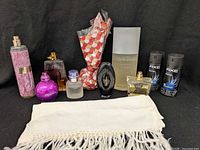 Group shot of all fragrances, two Axe cans and Forsyth scarf