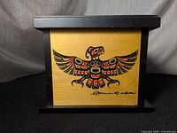 Front view showing eagle design and overall box form