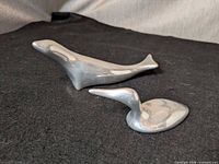 Front view of both aluminum sculptures showing forms and relative size
