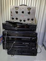 Full stack showing Teicol sweep generator atop four black audio components and connected cables