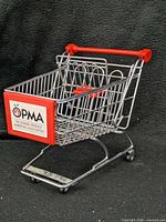 Full view of miniature cart front left side showing OPMA logo and red accents