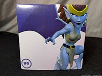 Front of Q-Fig Demona box showing character art and #99