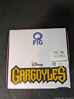 Top of Q-Fig Gargoyles box with logo and price sticker