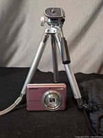Camera mounted on tripod with pouch visible