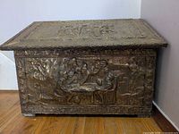 Front view showing embossed tavern scene and brass panels