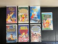 All seven Disney VHS tapes laid out for overview