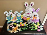 Group shot showing tinsel bunnies, freestanding bunny figures, wreath, Happy Easter sign, egg picks