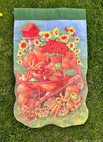 Vertical flag with wheelbarrow of pumpkins, sunflowers, birdhouse