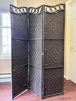 Full view of folded three-panel woven room divider