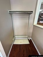 Full front view of freestanding metal coat rack