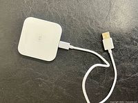Front view of Square reader showing tap symbol and attached USB cable